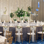Sophisticated wedding VIP table setup at Pan Pacific Hotel, showcasing fine dining elements and intricate floral centerpieces.