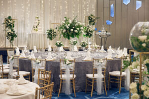 Sophisticated wedding VIP table setup at Pan Pacific Hotel, showcasing fine dining elements and intricate floral centerpieces.