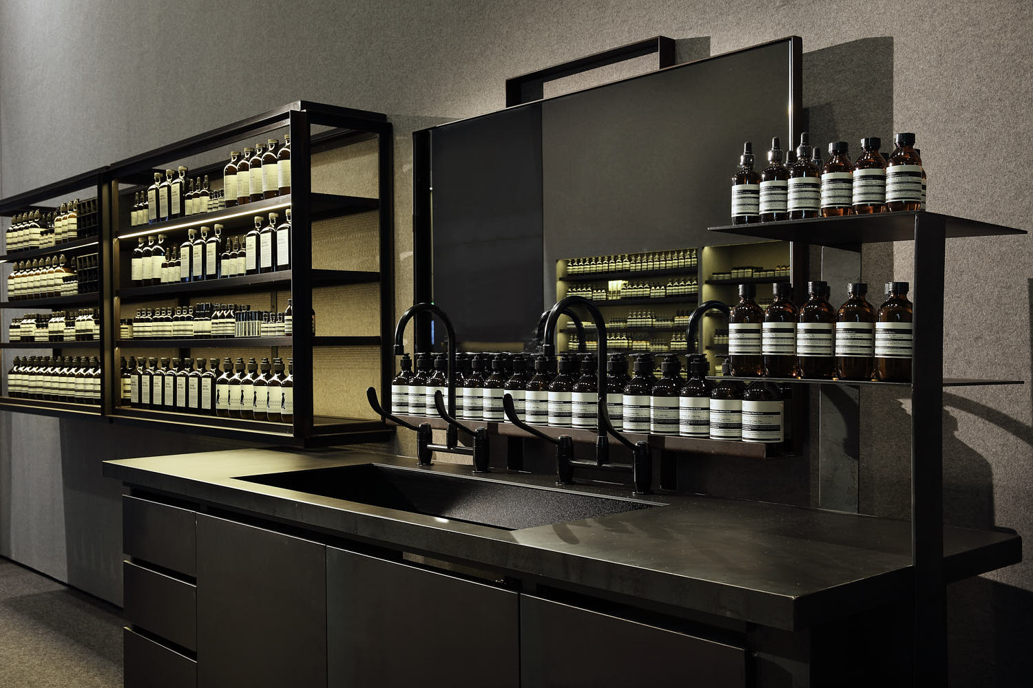 Interplay of suede, carpet, and brushed metal in Aesop’s interior palette.