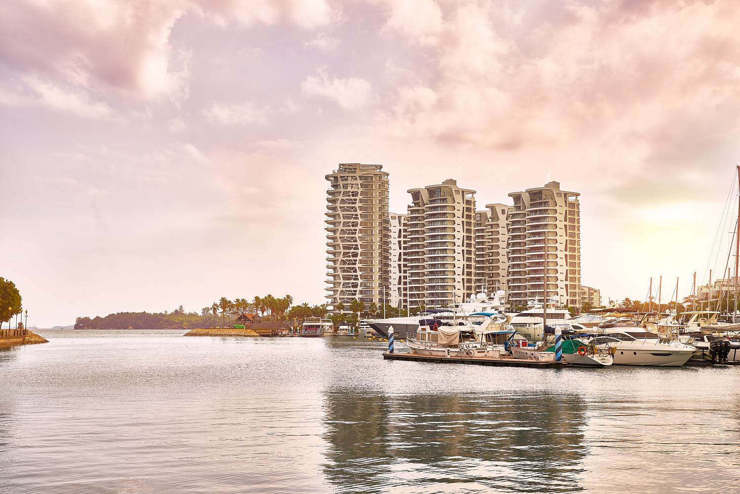 Cape Royale’s modern architecture bathed in warm sunset glow at Sentosa.