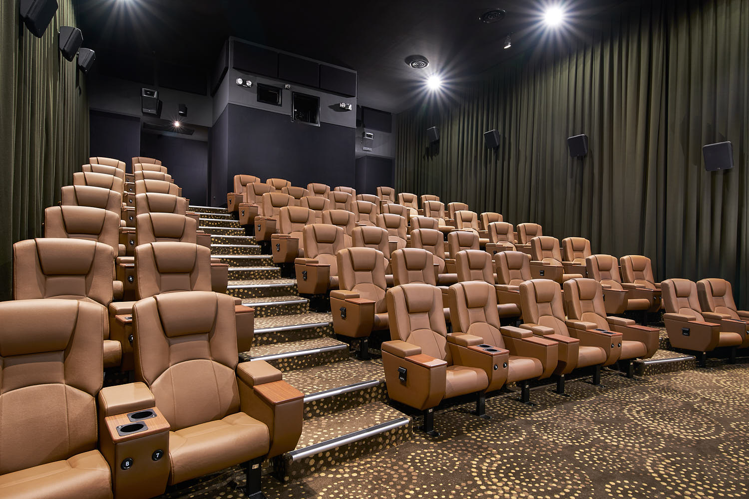 Spacious legroom and premium finishes enhance the luxury movie experience.