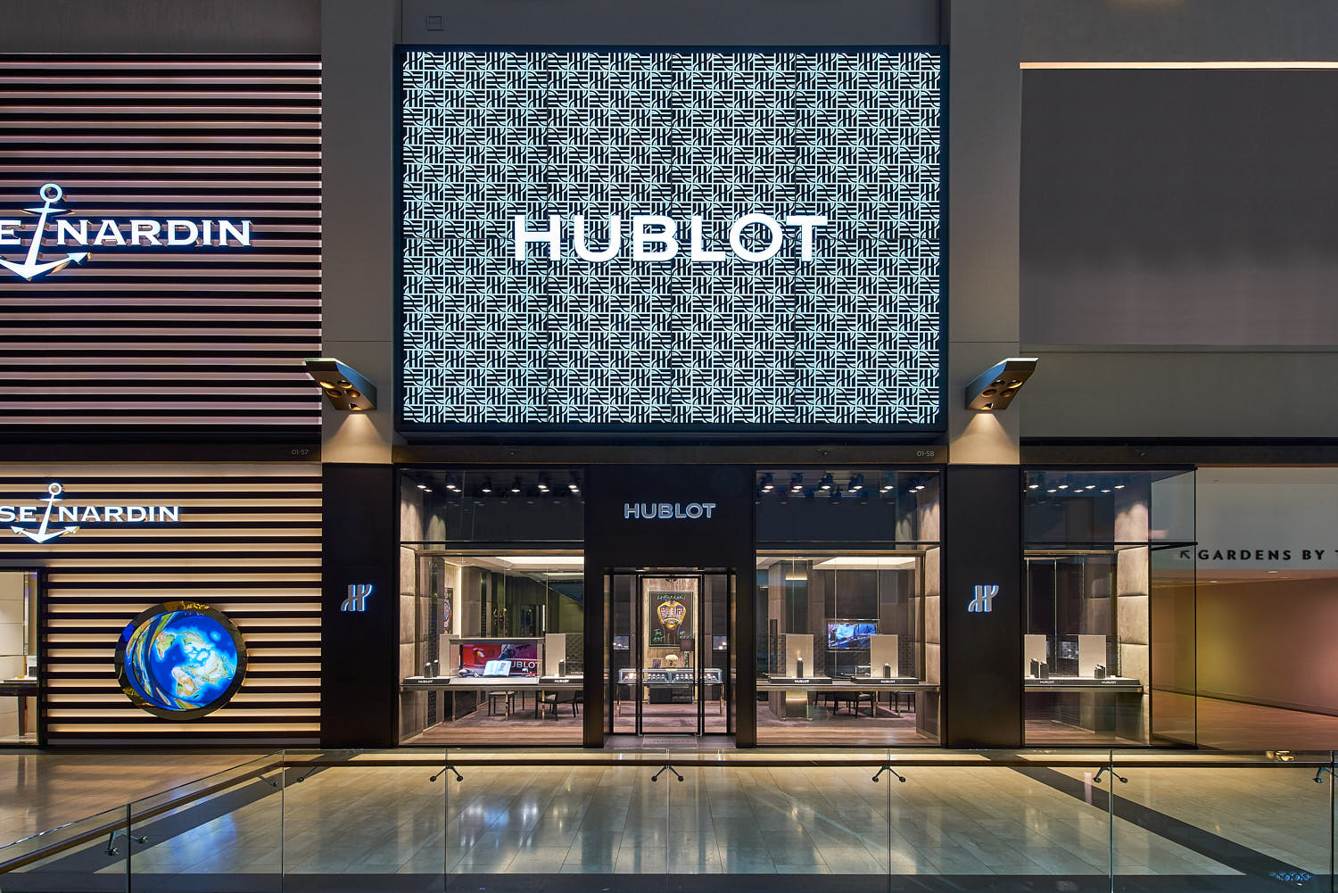Interior architecture of Hour Glass store with modern finishes and Hublot branding.