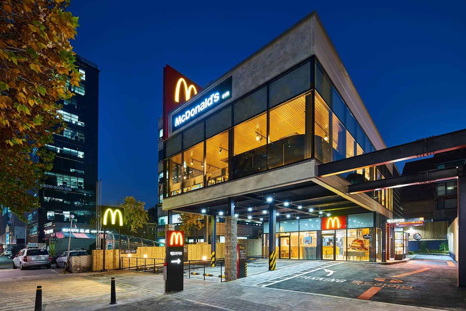 McDonald’s glass-front façade in Korea photographed at night.
