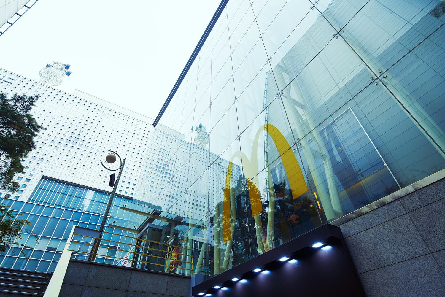 Modern McDonald’s façade in Korea with bold branding and glass exterior.
