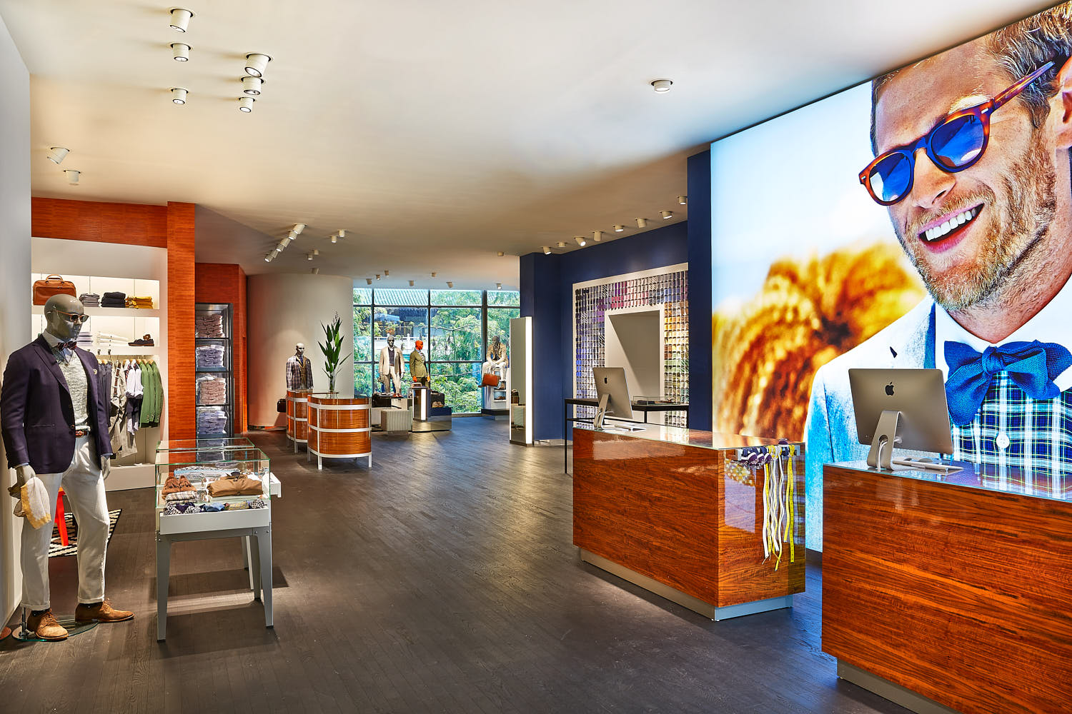 Color-block walls and modern fixtures in a men’s suit boutique.