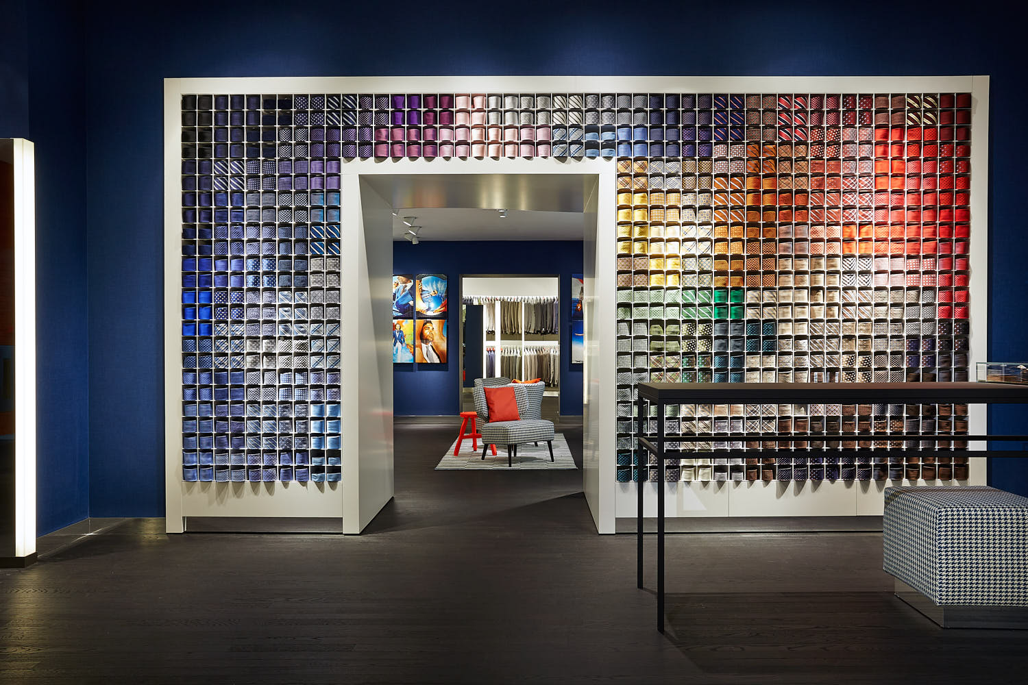 Vibrant interior of a modern men’s suit store with bold color accents.