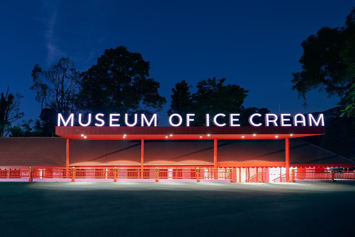 Museum of Ice Cream exterior façade illuminated at night with vibrant, colorful lighting.