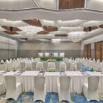 Grand meeting room setup at Pan Pacific Hotel Singapore with conference tables and stage.
