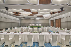 Grand meeting room setup at Pan Pacific Hotel Singapore with conference tables and stage.