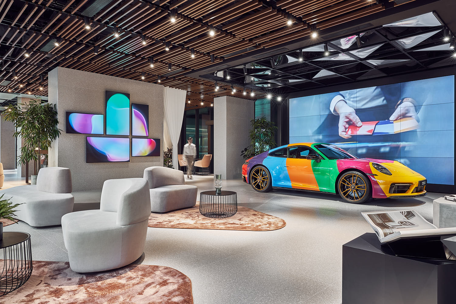 Elegant Porsche client lounge with designer seating and ambient lighting.