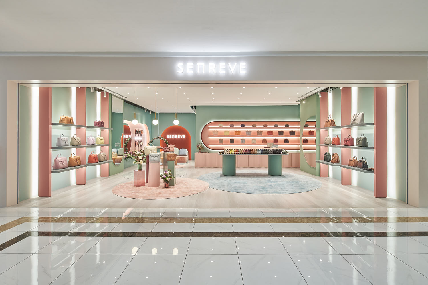 Pastel-themed Senreve store showcasing a variety of ladies’ purses and handbags.